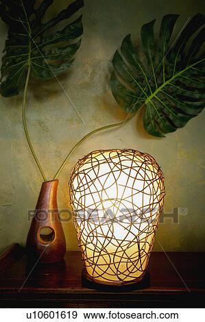Decorative globe lamp and plant on end table View Large Photo Image Stock Photo - Decorative globe lamp and plant on end table. Fotosearch