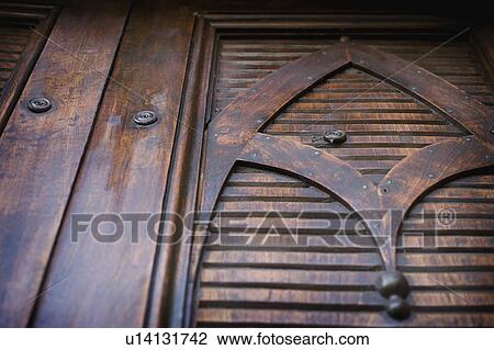 Stock Image - Detail carved wooden door. Fotosearch
