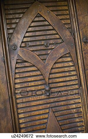 Stock Image - Detail carved wooden door. Fotosearch