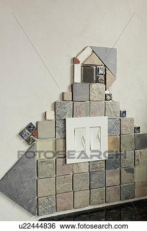 Stock Photograph - Detail mosaic tile work around light switch. Fotosearch
