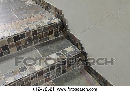 Stock Image - Detail mosaic tiles along steps. Fotosearch