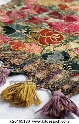 Stock Photograph - Detail of tassels on bed runner. Fotosearch