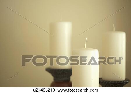 Stock Image - Detail set of white candles. Fotosearch