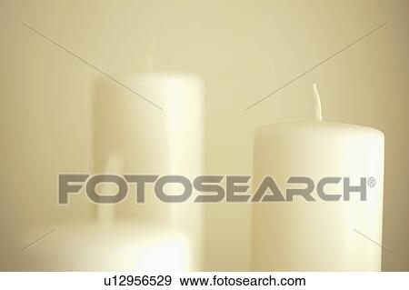 Stock Photo - Detail set of white candles. Fotosearch