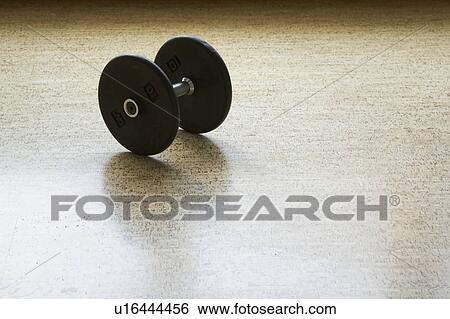 Stock Photograph - Dumbbell on wooden floor. Fotosearch