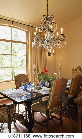 Stock Photograph - Elegant chandelier above dining room table. Fotosearch