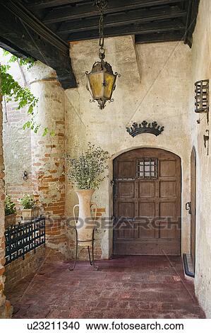 Entry with wooden doors and chain hanging light View Large Photo Image Stock Image - Entry with wooden doors and chain hanging light. Fotosearch