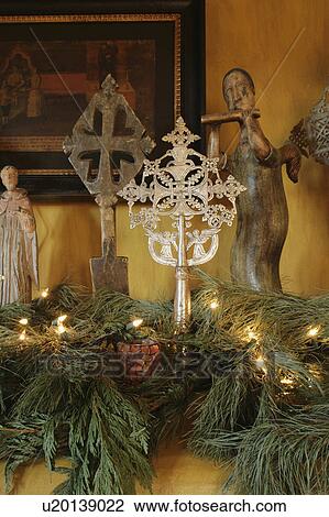 Stock Image - Figurines and crosses on mantle. Fotosearch