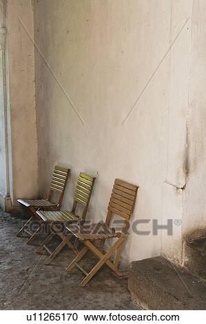 Stock Image - Folding chairs in Hacienda courtyard. Fotosearch