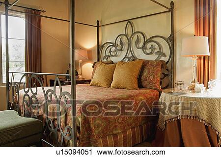 Four post bed with orange bedding View Large Photo Image Stock Image - Four post bed with orange bedding. Fotosearch