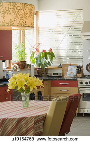 Stock Photo - Gold and red kitchen table in contemporary kitchen. Fotosearch