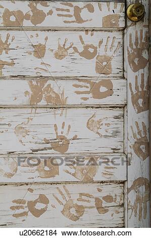 Picture - Hand prints on Native American door. Fotosearch