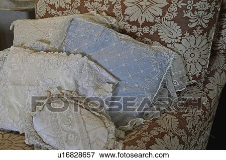 Stock Photo - Lacy throw pillows on chaise lounge. Fotosearch