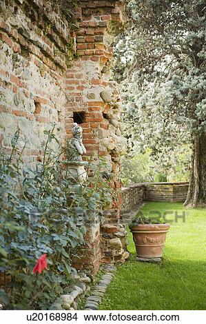 Picture - Landscaping along side of old brick and concrete castle. Fotosearch
