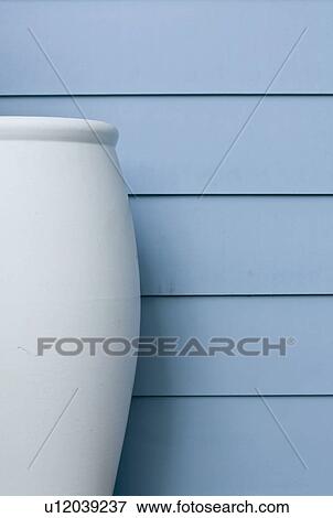 Large blue vase along blue siding View Large Photo Image Stock Photo - Large blue vase along blue siding. Fotosearch