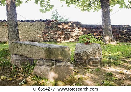 Stock Photo - Large stone bench in yard. Fotosearch