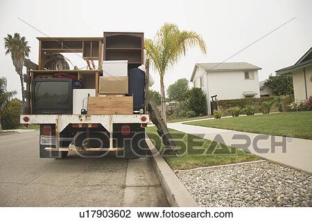 Stock Image - Moving truck loaded with boxes and furniture. Fotosearch