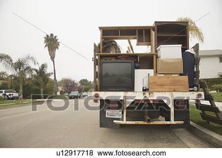 Stock Photo - Moving truck loaded with boxes and furniture. Fotosearch