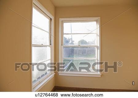 Stock Photo - Old windows in corner of empty room. Fotosearch