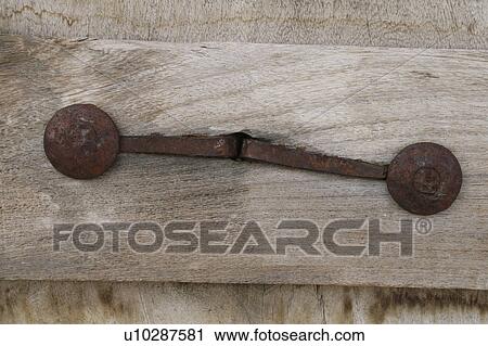 Stock Image - Old wooden door and iron detail. Fotosearch