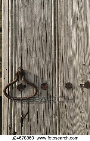 Stock Image - Old wooden door and iron detail. Fotosearch