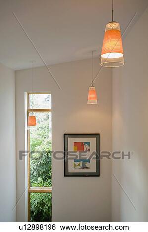 Stock Photograph - Pendant lights above steps in contemporary home. Fotosearch