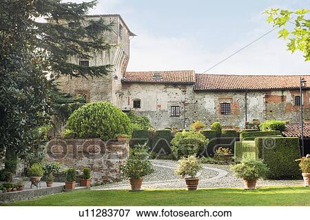 Stock Photo - Potted plants lining driveway of historic Italian castle. Fotosearch