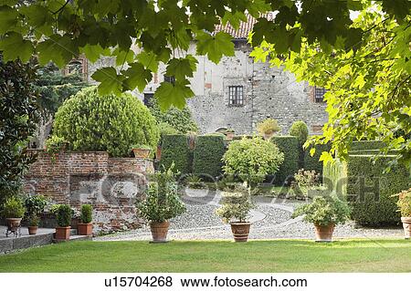 Stock Photo - Potted plants lining driveway of historic Italian castle. Fotosearch