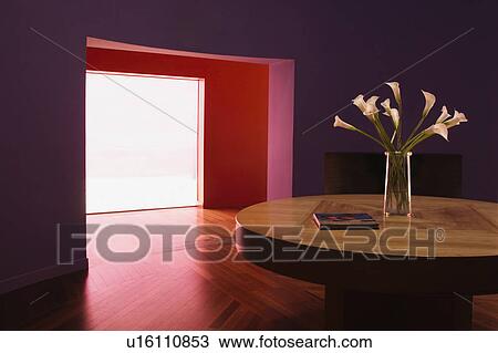 Stock Image - Purple room with large doorway and circular table. Fotosearch