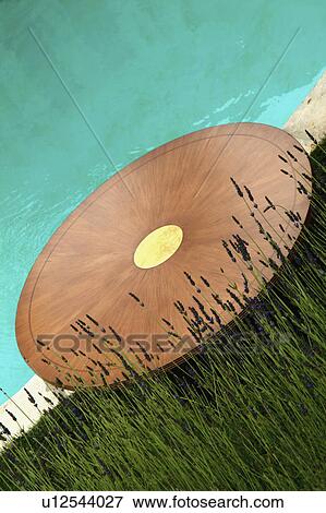 Round table on edge of swimming pool View Large Photo Image Stock Photo - Round table on edge of swimming pool. Fotosearch
