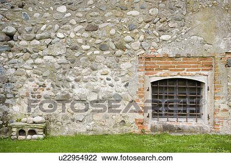 Stone wall with barred off window View Large Photo Image Stock Image - Stone wall with barred off window. Fotosearch