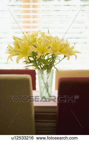 Vase of yellow flowers on red and gold kitchen table View Large Photo Image Stock Photograph - Vase of yellow flowers on red and gold kitchen table. Fotosearch