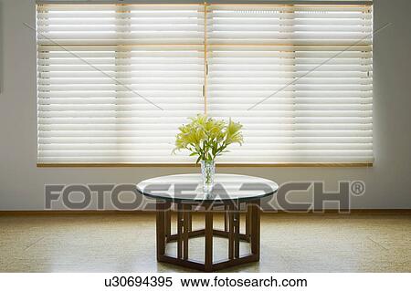 Vase of yellow flowers on table below window View Large Photo Image Stock Photography - Vase of yellow flowers on table below window. Fotosearch
