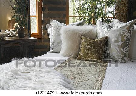 White And Gold Bed Runner And Pillows On Bed Stock Image U12314791 Fotosearch