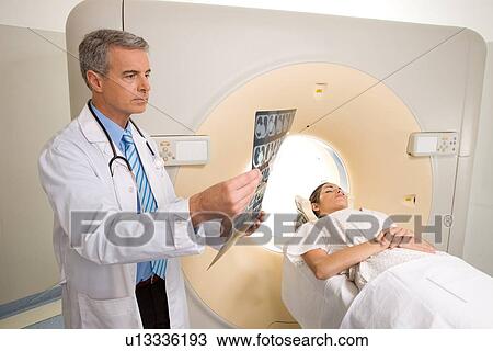 Stock Image - Analyzing a brain scan. Fotosearch