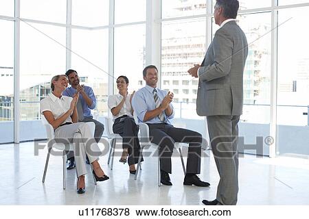 Stock Photo - Applauding a speaker. Fotosearch