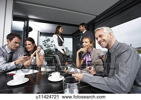 At a business meeting View Large Photo Image Stock Image - At a business meeting. Fotosearch