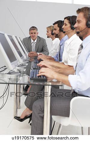 Stock Photography - At a call center. Fotosearch