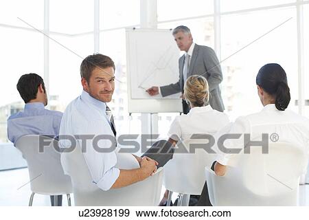 Stock Photo - At a presentation. Fotosearch