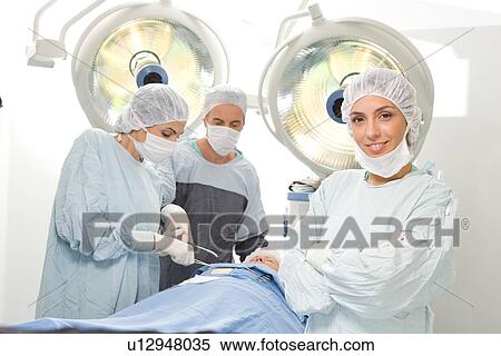 Attractive surgeon smiling View Large Photo Image Stock Photography - Attractive surgeon smiling. Fotosearch