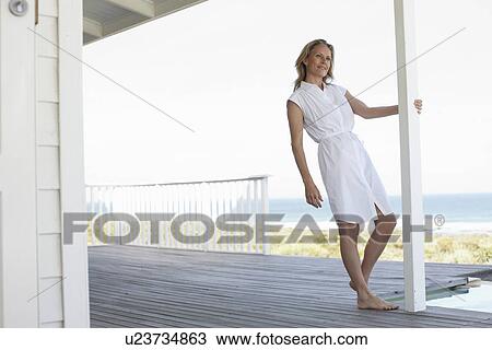 Stock Image - Attractive woman close to the sea. Fotosearch