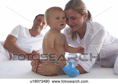 Baby holding feeding bottle View Large Photo Image Stock Image - Baby holding feeding bottle. Fotosearch