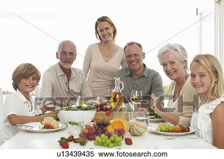 Beautiful family having lunch View Large Photo Image Stock Photography - Beautiful family having lunch. Fotosearch