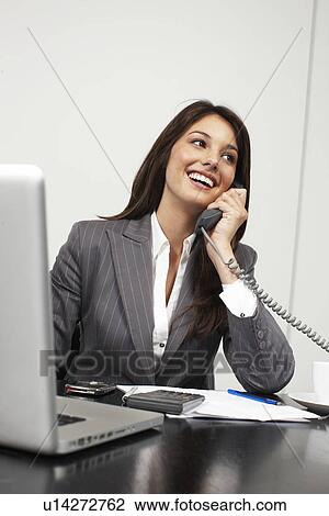 Stock Image - Beautiful girl on phone. Fotosearch
