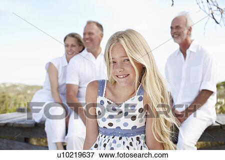 Beautiful girl with her family View Large Photo Image Stock Photo - Beautiful girl with her family. Fotosearch