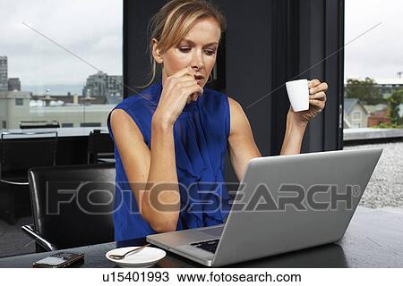 Stock Image - Beautiful woman at work. Fotosearch