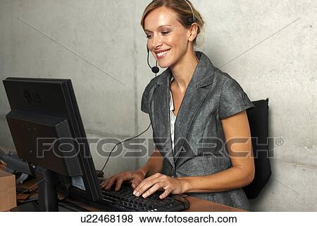 Stock Photo - Beautiful woman at work. Fotosearch