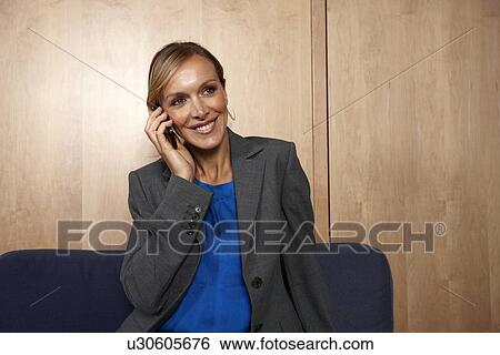 Stock Photograph - Beautiful woman on a phone. Fotosearch