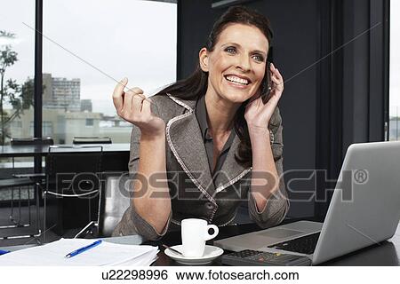 Stock Photograph - Beautiful woman on phone. Fotosearch