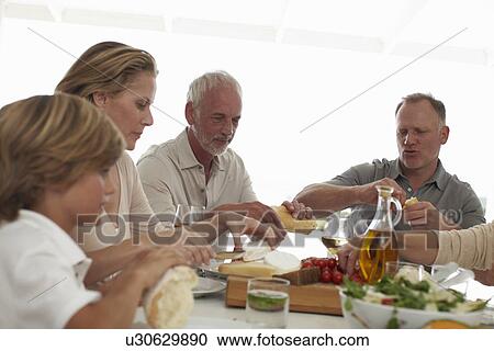 Big family having lunch View Large Photo Image Stock Image - Big family having lunch. Fotosearch